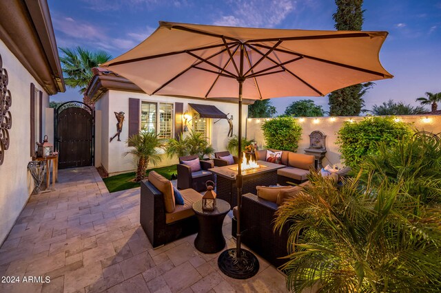 patio terrace at dusk featuring an outdoor living space