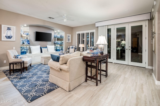 living room with french doors, ceiling fan, and hardwood / wood-style floors