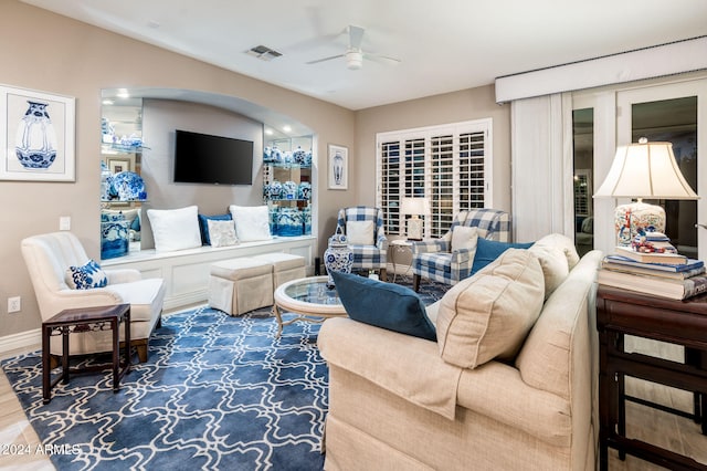 living room featuring hardwood / wood-style floors and ceiling fan