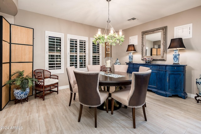 dining room featuring light hardwood / wood-style flooring and a notable chandelier