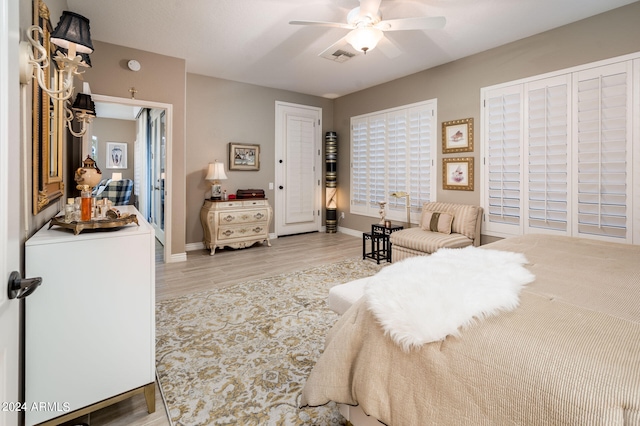 bedroom with light hardwood / wood-style floors and ceiling fan