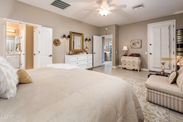 bedroom featuring light hardwood / wood-style flooring, ceiling fan, and ensuite bath