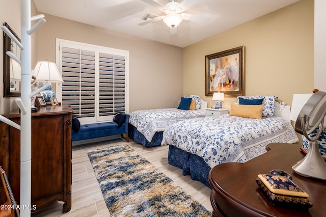 bedroom with ceiling fan and light wood-type flooring