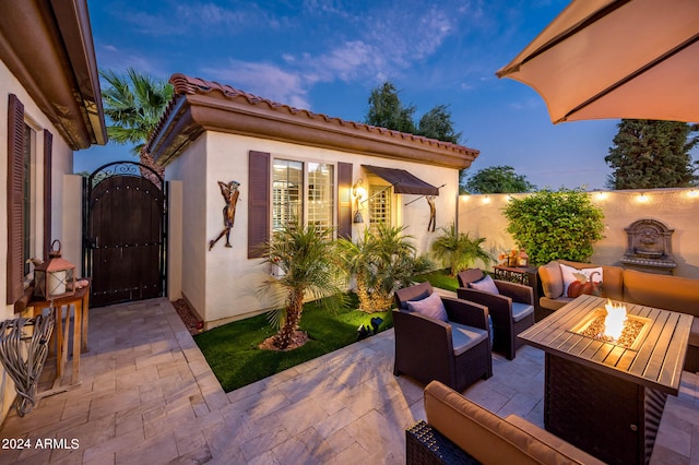 patio terrace at dusk with an outdoor hangout area