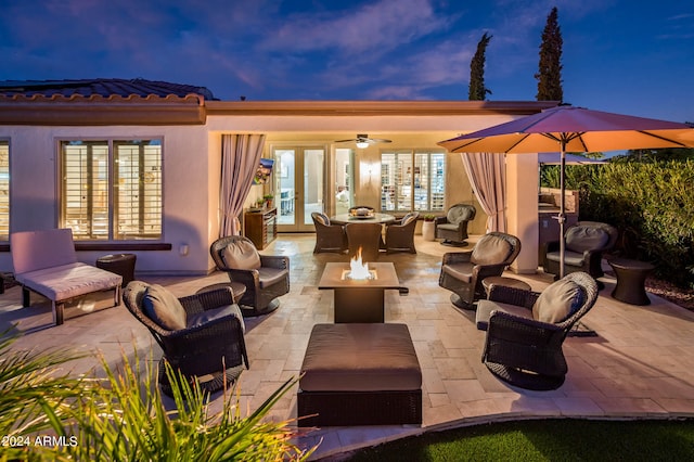 patio terrace at dusk with french doors, outdoor lounge area, and ceiling fan