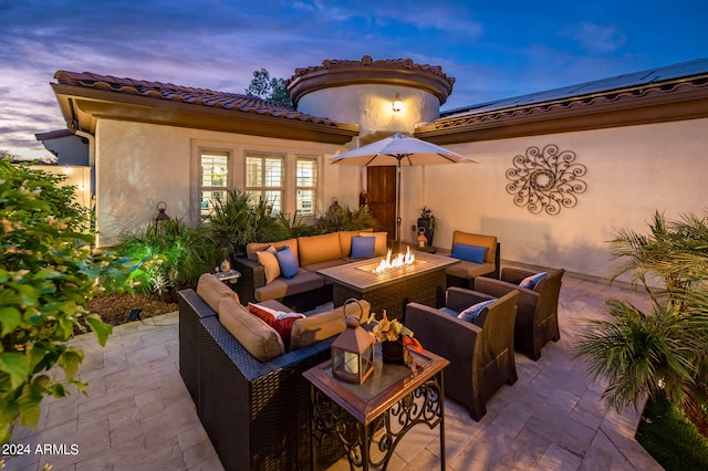 patio terrace at dusk featuring an outdoor hangout area