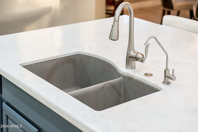 room details with blue cabinetry and sink