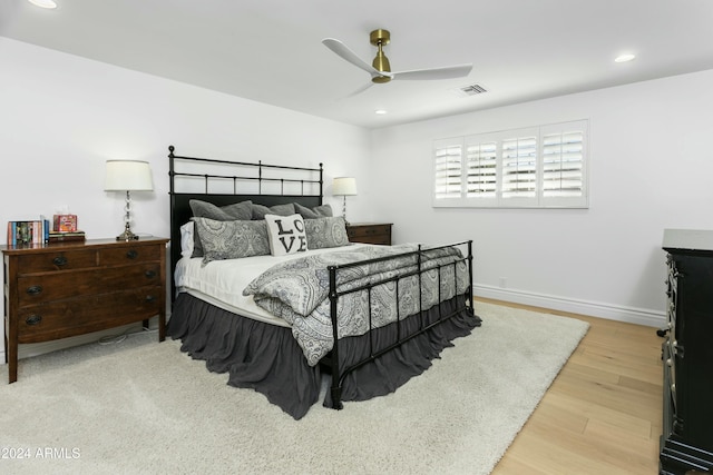 bedroom with wood-type flooring and ceiling fan