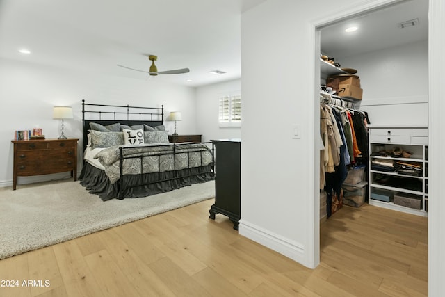 bedroom featuring ceiling fan, a spacious closet, hardwood / wood-style floors, and a closet