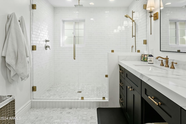 bathroom with vanity and a shower with door