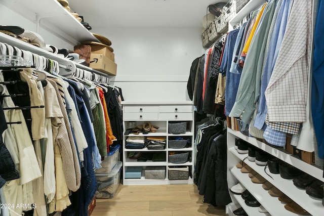 spacious closet with light hardwood / wood-style floors