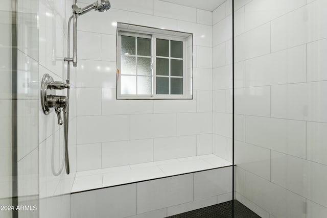 bathroom with a tile shower