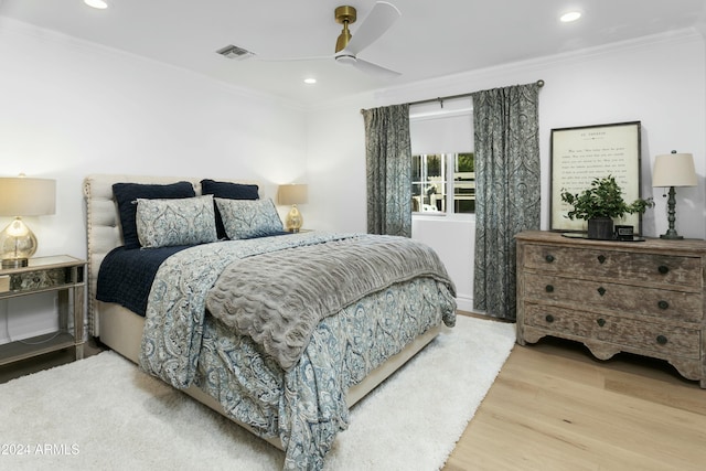 bedroom featuring crown molding, ceiling fan, and light wood-type flooring