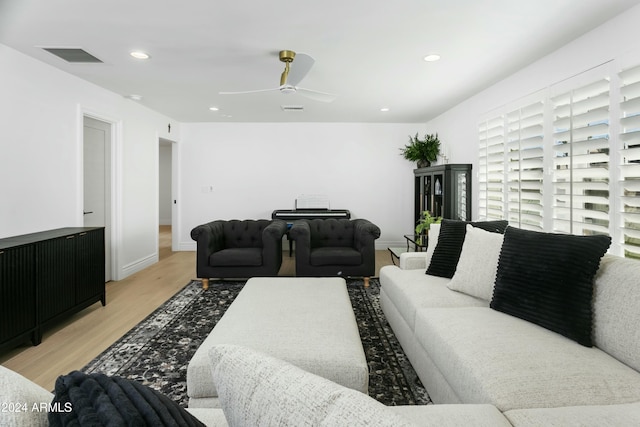 living room featuring ceiling fan and light hardwood / wood-style floors