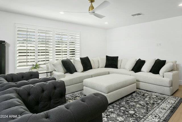 living room with wood-type flooring and ceiling fan