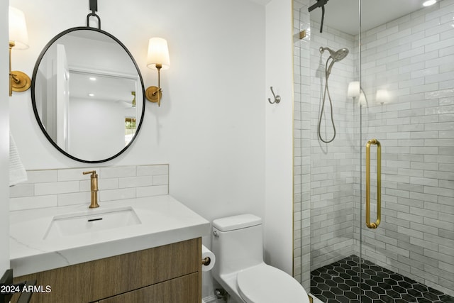 bathroom featuring tasteful backsplash, vanity, walk in shower, and toilet