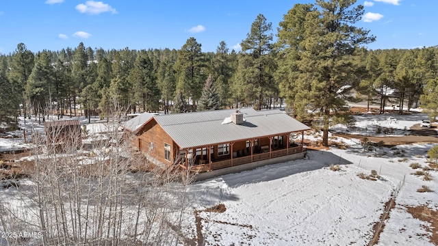 snowy aerial view with a forest view