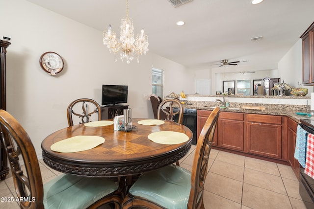 tiled dining area featuring ceiling fan with notable chandelier and sink