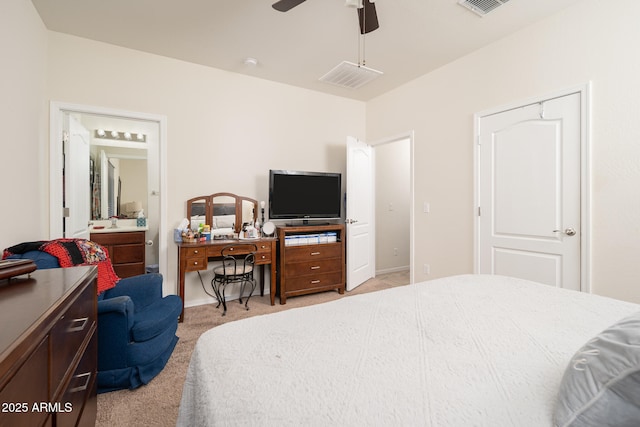 carpeted bedroom featuring ensuite bath, ceiling fan, and sink