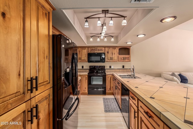 4245 E Yawepe St, Phoenix, AZ 85044 - kitchen with brown cabinets, a sink, a raised ceiling, black appliances, and a peninsula