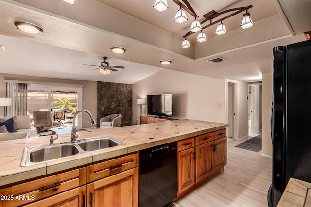 4245 E Yawepe St, Phoenix, AZ 85044 - kitchen featuring black appliances, open floor plan, brown cabinets, and a sink