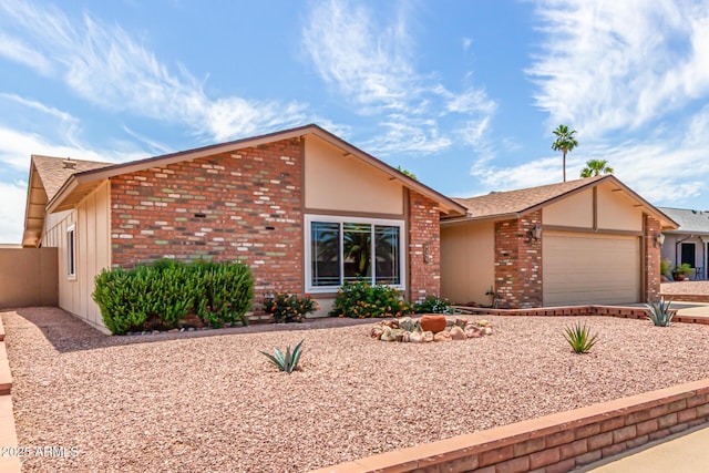 4245 E Yawepe St, Phoenix, AZ 85044 - mid-century modern home with driveway, an attached garage, and brick siding
