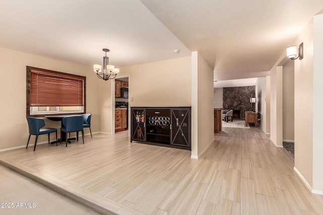 4245 E Yawepe St, Phoenix, AZ 85044 - living room with baseboards, a notable chandelier, and light wood finished floors