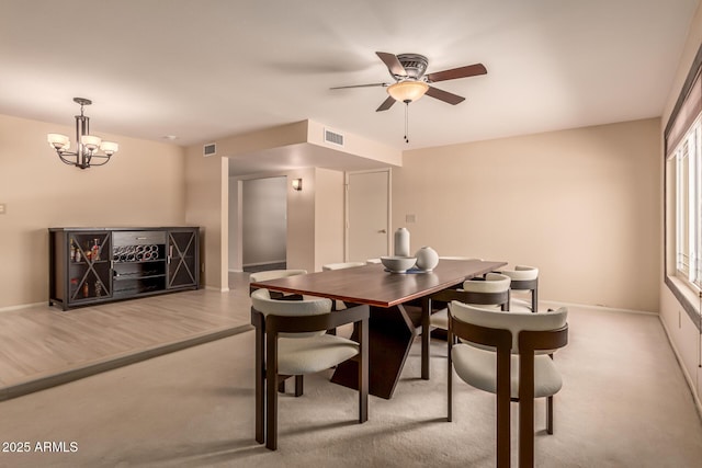 4245 E Yawepe St, Phoenix, AZ 85044 - carpeted dining space featuring a wealth of natural light, visible vents, baseboards, and ceiling fan with notable chandelier