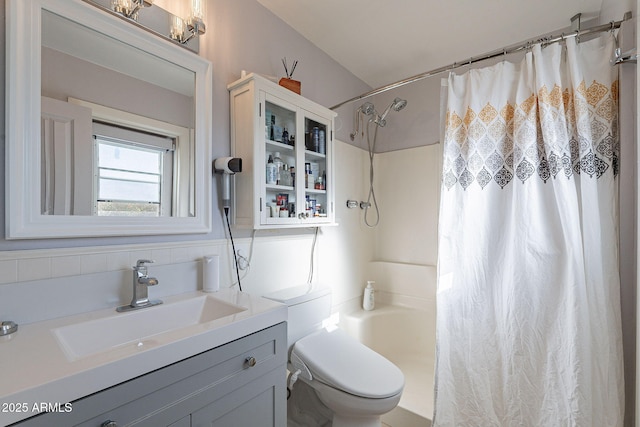 full bathroom featuring vanity, toilet, and shower / tub combo with curtain