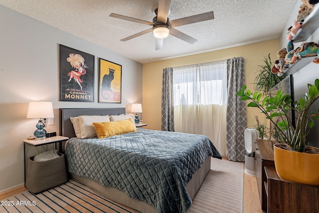 bedroom with ceiling fan and a textured ceiling