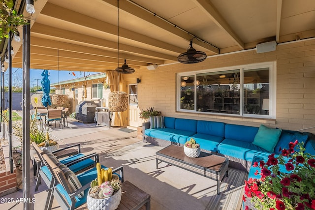 view of patio with an outdoor living space and ceiling fan