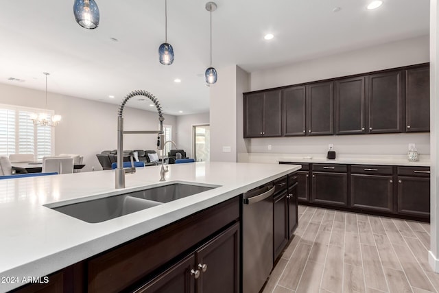 kitchen featuring dishwasher, sink, decorative light fixtures, dark brown cabinets, and light wood-type flooring