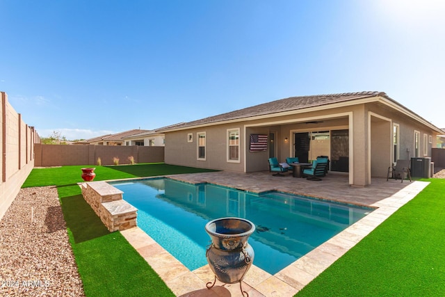 view of pool featuring a lawn and a patio area