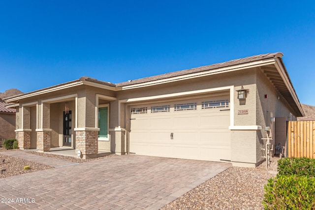 view of front of property with covered porch and a garage