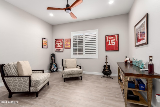 living area featuring ceiling fan and light hardwood / wood-style flooring