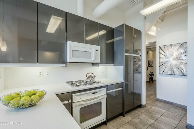 kitchen with light tile patterned flooring and white appliances