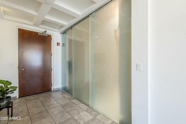 corridor featuring light tile patterned floors, beamed ceiling, and coffered ceiling