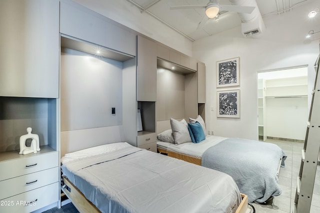 bedroom with a closet, a spacious closet, and ceiling fan