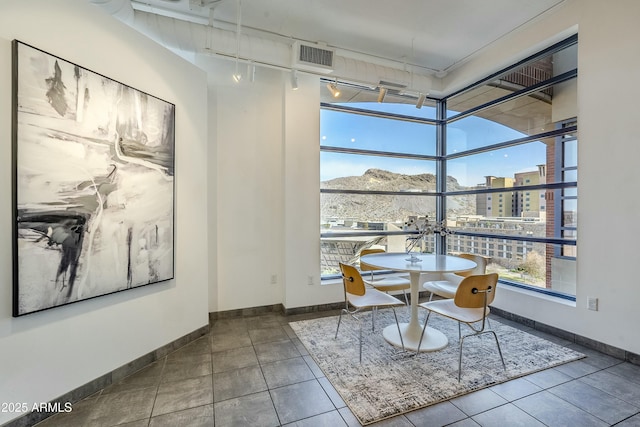 tiled dining room with a mountain view