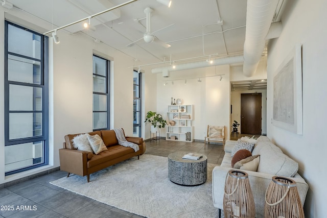 living room featuring ceiling fan, dark tile patterned floors, and track lighting