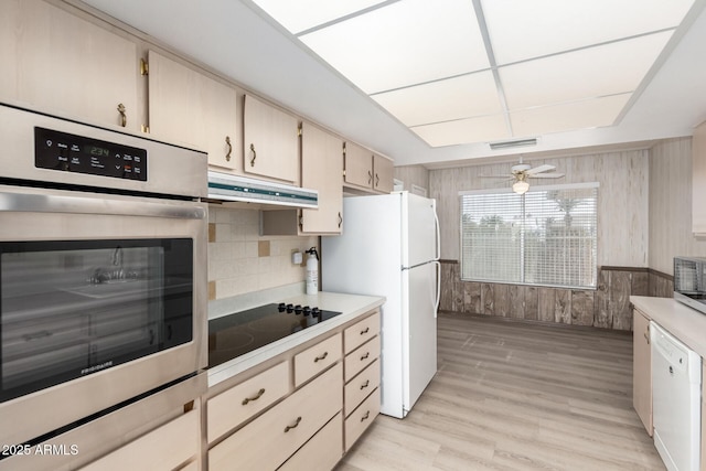 kitchen with white appliances, light hardwood / wood-style flooring, ceiling fan, hanging light fixtures, and tasteful backsplash