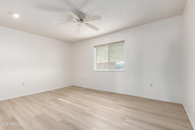 unfurnished room featuring ceiling fan, a textured ceiling, and light wood-type flooring