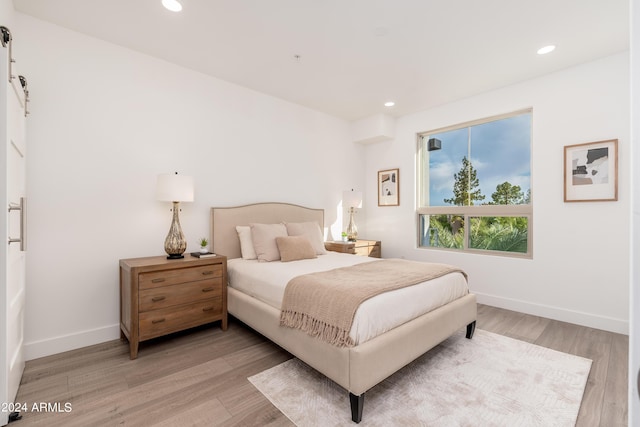 bedroom featuring recessed lighting, light wood-type flooring, and baseboards