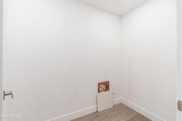 washroom with light wood-style flooring and baseboards