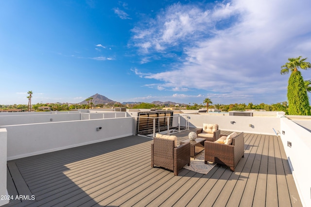 wooden deck featuring outdoor lounge area and a mountain view