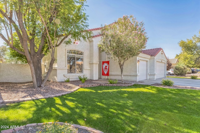 mediterranean / spanish home with a garage and a front yard