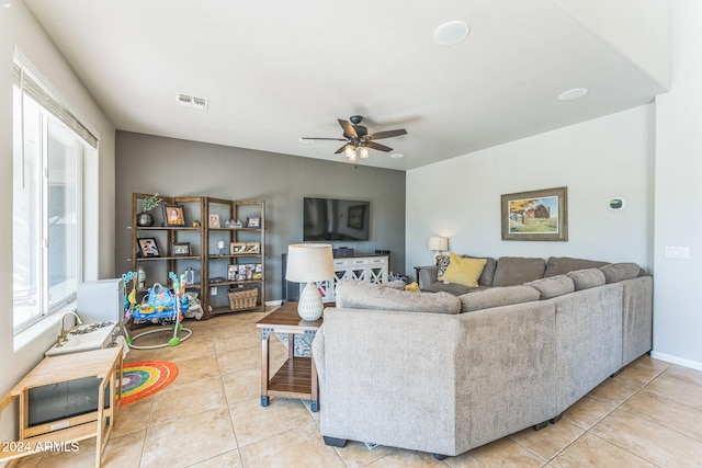 tiled living room featuring ceiling fan