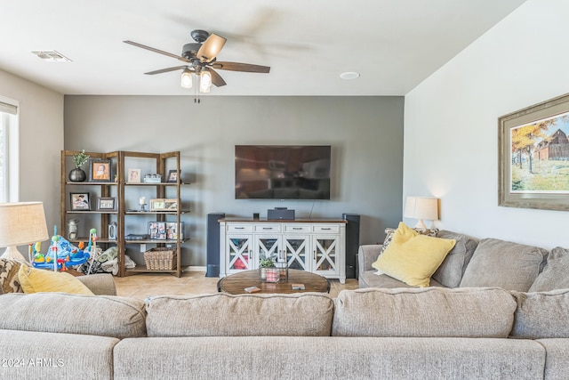 living room with ceiling fan and light tile patterned flooring