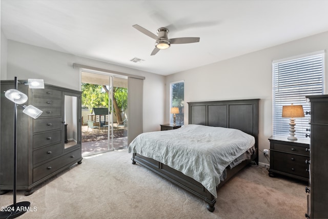 bedroom with access to outside, light colored carpet, and ceiling fan