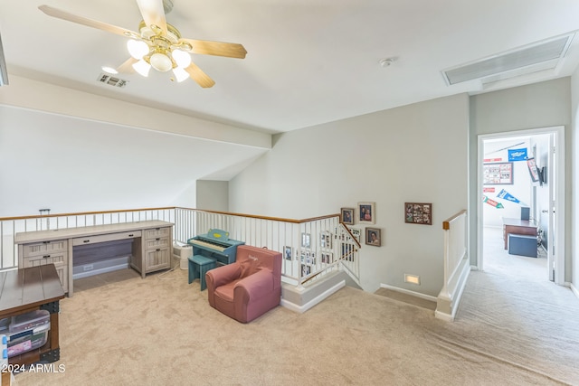 living area with light colored carpet and ceiling fan